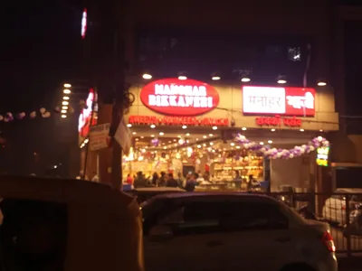 Illuminated shop boards in Krishna Nagar, Delhi, are the kind of face an AMC keeps lit.