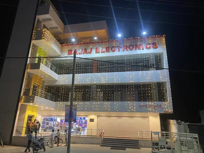 An installed shop sign sits on a panel facade in Gadwal.