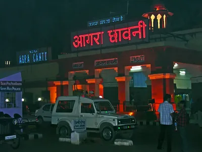 A neon sign at Agra Cantonment station is the kind of face a repair crew relights.