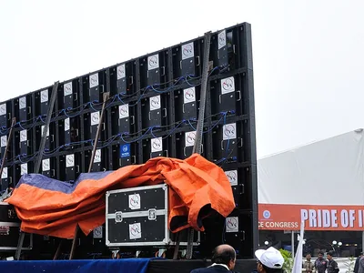 Open LED modules on a wall in Kolkata show the parts a repair crew replaces.