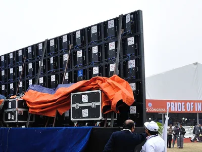 Signage servicing opens the back of an LED module wall in Kolkata.